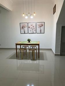 a dining room table and chairs in a white room at SW Homestay Kota Warisan, Sepang in Sepang +10 photos
