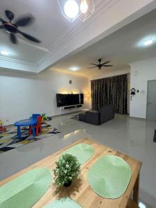 a living room with a table and a couch at SW Homestay Kota Warisan, Sepang in Sepang