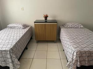 two beds sitting next to each other in a room at Casa Grande Centro in Rio Verde