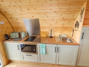 a small kitchen with a sink and a stove at Moel Arthur in Denbigh +9 photos