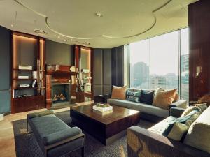 a living room with a couch and a fireplace at Crown Park Hotel Seoul Myeongdong in Seoul