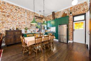 a kitchen and dining room with a brick wall at Arapiles Club House in Natimuk
