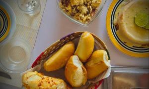 a basket of bread and a bowl of food on a table at Casa San Francisco in Porto Seguro +2 photos