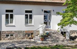 a white house with stairs in front of it at Ferienwohnung Nicole in Gurvitz