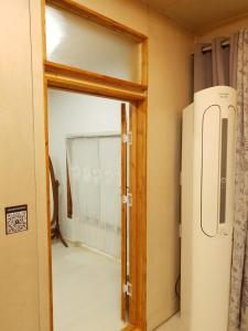 an open door to a room with a refrigerator at 한옥스테이 오늘 Hanok Stay Ohneul in Gyeongju