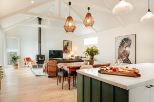 a kitchen and living room with a table with fruit on it at Dorothea- stylishly designed home in Trentham in Trentham