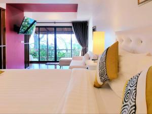 a hotel room with a large bed and a couch at Nangyuan Island Dive Resort in Ko Tao
