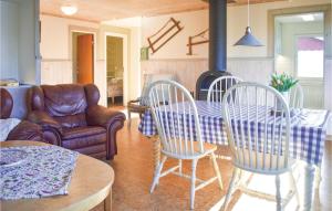 a living room with a table and chairs and a couch at 3 Bedroom Gorgeous Home In Holmsjö in Holmsjö