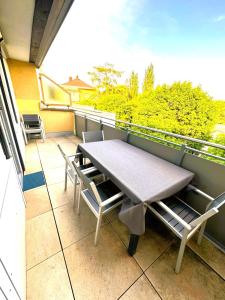 a table and chairs on a balcony with a view at University Messe Apartment in Graz