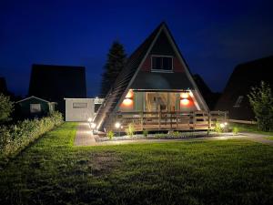 a house with lights in the yard at night at meinhaus-fedderwardersiel in Butjadingen