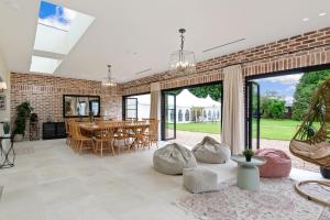 a living room with a brick wall and a table at Minstrel Court Wedding Venue in Cambridge