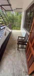 an empty room with a bench and a balcony at Green Heaven Kumarakom in Kumarakom