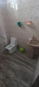 a bathroom with a toilet and a sink at Green Heaven Kumarakom in Kumarakom