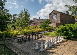 un ajedrez en una acera frente a una casa en Blaithwaite Country House Estate en Wigton