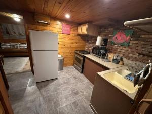 a kitchen with a white refrigerator and a sink at The Beach Cave in Santa Rosa Beach +11 photos