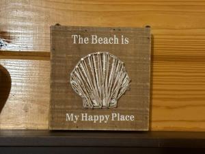 a sign that says the beach is my happy place at The Beach Cave in Santa Rosa Beach