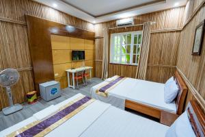 Postel nebo postele na pokoji v ubytování Resort HTC Tuần Châu