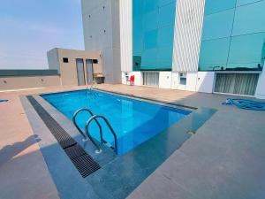 a swimming pool on top of a building at Hotel Kunal Palace in Ahmadnagar