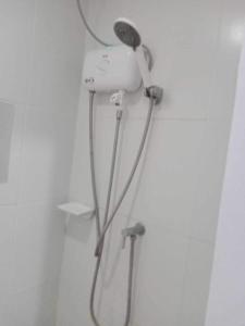a blow dryer is hanging on a wall at Minimalist Condo Studio City Tower 2 Filinvest Alabang Muntinlupa in Manila