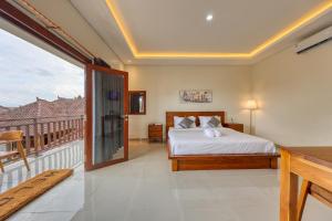 a bedroom with a bed and a balcony at The Kanka Beach House in Nusa Penida