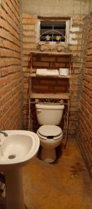 a bathroom with a toilet and a sink at Villas Carmelita hostal in Paso de las Palmas +6 photos