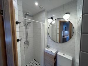a bathroom with a shower and a sink and a mirror at Jon´s 2 Apartments in Pärnu