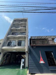 a tall building with a eiffel tower on it at LAZYHOUSE 別邸 in Okayama
