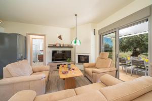 a living room with two couches and a table at Villa Elia Kefalonia by Olea Villas in Argostoli