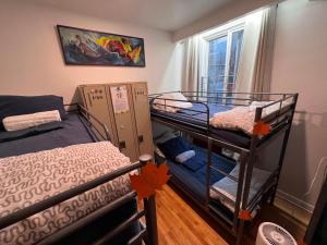 a room with two bunk beds and a window at Auberge PVT Hostel in Montreal