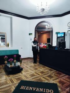 a man is standing in a room at GREEN ORCHID HOSTEL Miraflores Lima in Lima