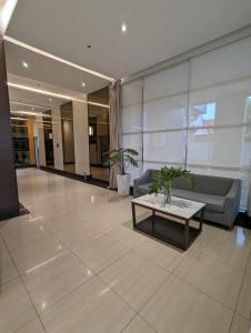 a lobby with a couch and a table in a building at Joyce Condo @ Centrio Towers in Cagayan de Oro +6 photos