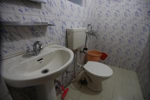 a bathroom with a white sink and a toilet at Odbar Guest House Best Guest House at Leh Ladakh in Leh +47 photos