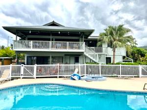 a house with a swimming pool in front of a house at Ocean Breeze Kona Home in Kailua-Kona