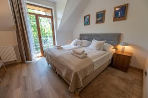 a bedroom with a bed with towels on it at Rezydencja Familia in Świnoujście +97 photos