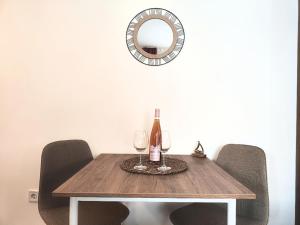 a table with two wine glasses and a mirror at Bofani Apartments Budva in Budva +10 photos