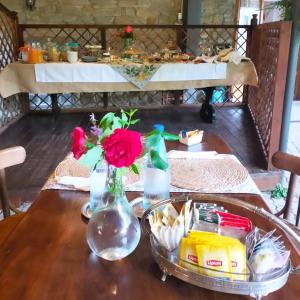 a wooden table with a vase with flowers in it at Albergo Diffuso Locanda Senio in Palazzuolo sul Senio