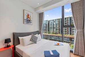 a bedroom with a bed and a large window at The Artistry Apartment Cental Saigon Heart Center in Ho Chi Minh City +261 photos