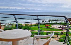 a balcony with a table and chairs and the ocean at Амон Ра in Primorsko