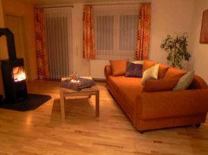 a living room with a couch and a wood stove at Wetekams Ferienwohnung W5 in Diemelstadt 