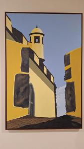 a painting of a yellow building with a tower at Theo's City House in Funchal