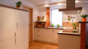 eine Küche mit weißen Schränken und einer Spüle in der Unterkunft Wetekams Ferienwohnung W2 in Diemelstadt  + 14 Fotos