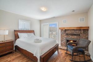 a bedroom with a bed and a fireplace at Spacious 4BDR Blue Haven Cottage in Grand Haven 150 in Grand Haven