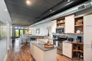 a kitchen with white cabinets and a counter top at Luxurious 2BDR Loft Condo with Stunning Views in Grand Haven in Grand Haven