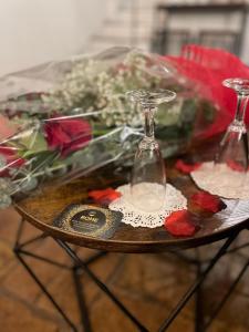 a table with a hourglass and flowers on it at Rome SuiteRelax in Rome