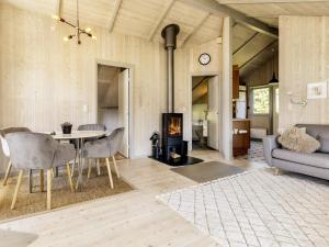 a living room with a table and a fireplace at 4 star holiday home in Præstø-By Traum in Præstø