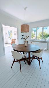 a dining room with a table and two chairs at Rotes Småland - Haus, Schweden, ideal für Familien, See in der Nähe in Silverdalen