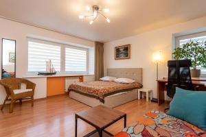 a hotel room with a bed and a couch at Nidos Laivas in Nida
