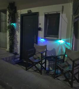 a group of chairs in front of a house with lights at St.Barbara studio in Drama