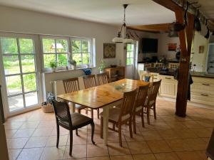 a kitchen with a wooden table and chairs at Ferienwohnung Segeln und Angeln in Grabowhöfe