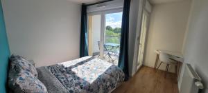 a bedroom with a bed and a view of a balcony at Cozy apartment at Paris doors with free car-park in Saint-Denis